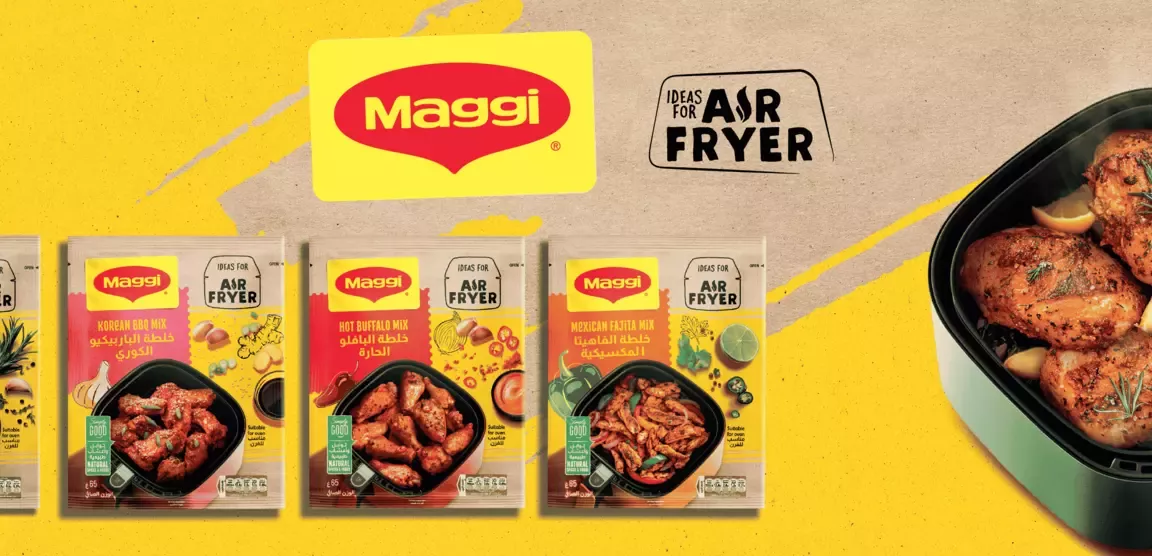 An Airfryer with food and Maggi packages on the table