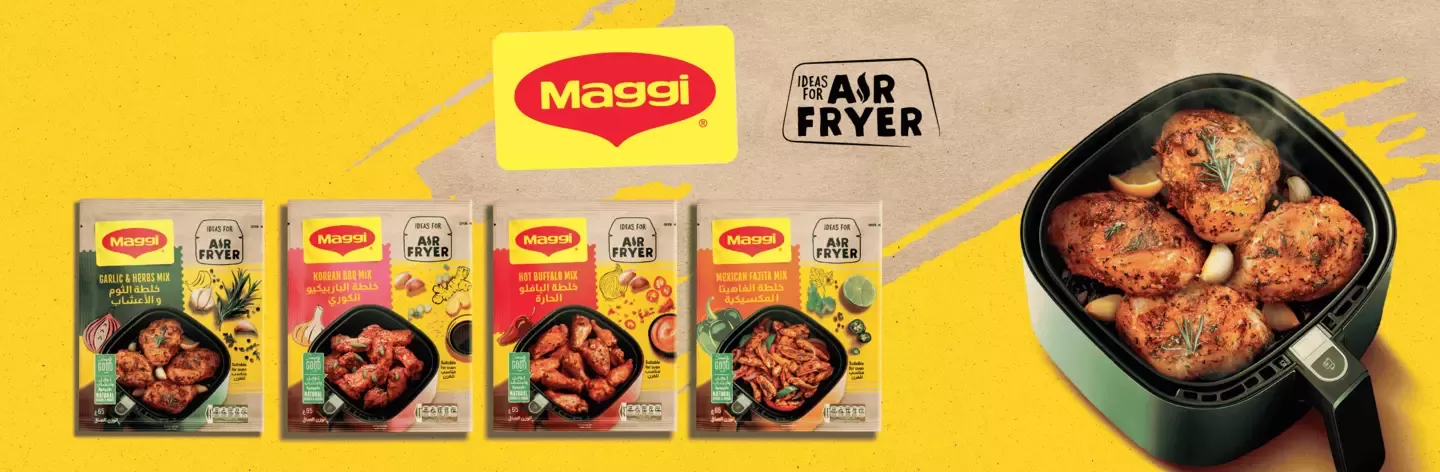 An Airfryer with food and Maggi packages on the table