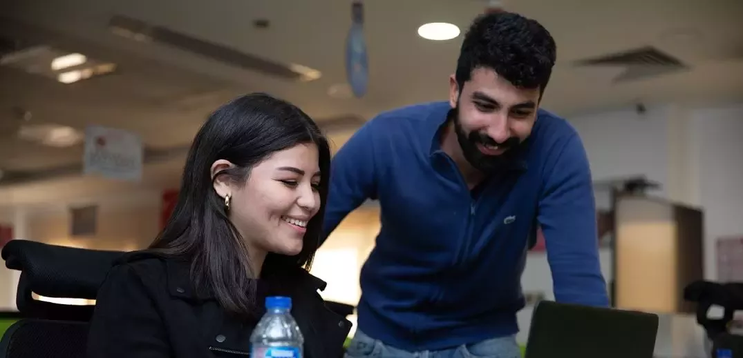 colleagues looking at a laptop
